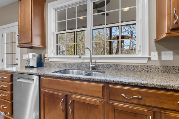 a kitchen with granite countertop stainless steel appliances and wooden cabinets