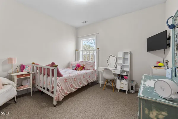 a living room with furniture a fireplace and a floor to ceiling window