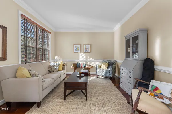 a living room with furniture and a hard wood floor