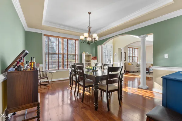 a view of a a dining room with furniture window and wooden floor
