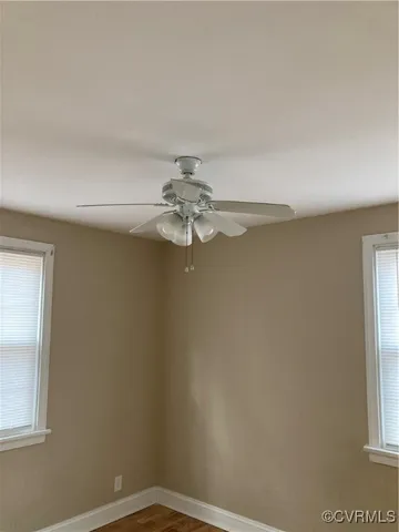 a room with wooden floor and white walls