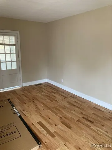 an empty room with wooden floor