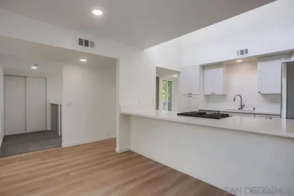 a kitchen with stainless steel appliances a sink a stove a refrigerator and cabinets
