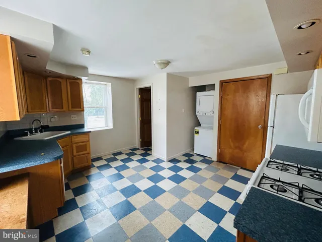 a view of a kitchen with a stove cabinets and a window