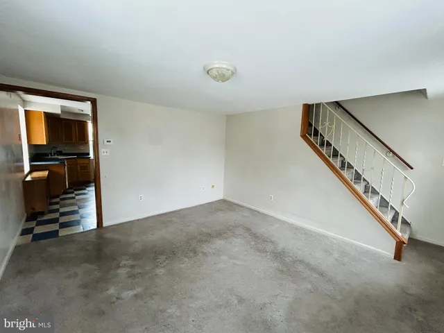 a view of an empty room with stairs