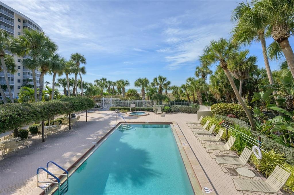 6285 Midnight Pass Road, Unit 403 Sarasota, FL 34242 - Photo 44 of 51 a view of swimming pool from a lounge chair