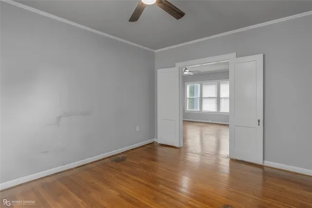 wooden floor in an empty room with a window
