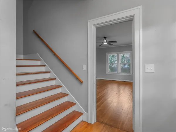 a view of entryway and hall with wooden floor