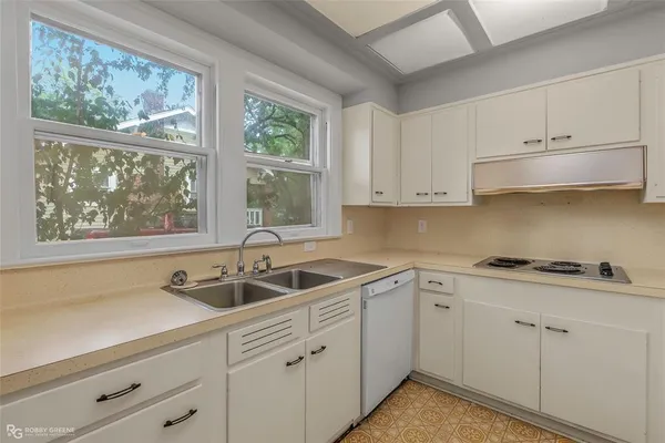 a kitchen with white cabinets and a sink
