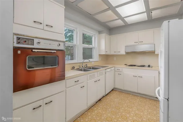 a kitchen with sink cabinets and window
