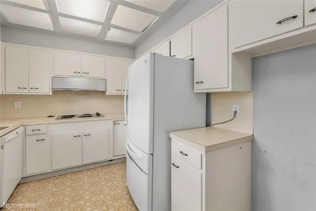 a kitchen with cabinets appliances and a counter space