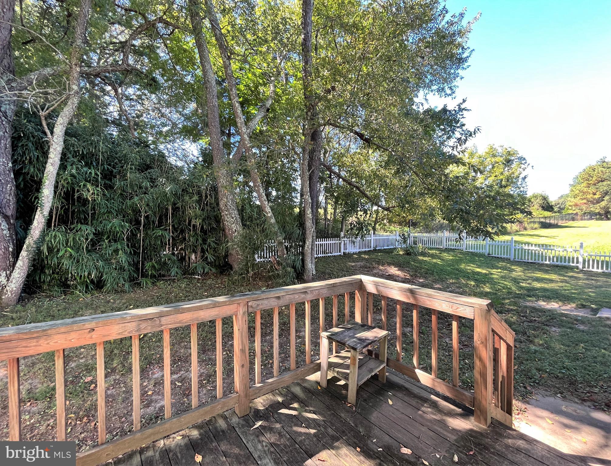 157 Cove Point Road Lusby, MD 20657 - Photo 18 of 19 a view of a wooden deck with chairs and a yard