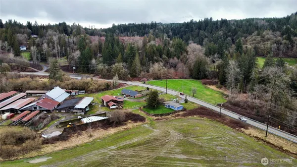 an aerial view of a house with a garden and lake view