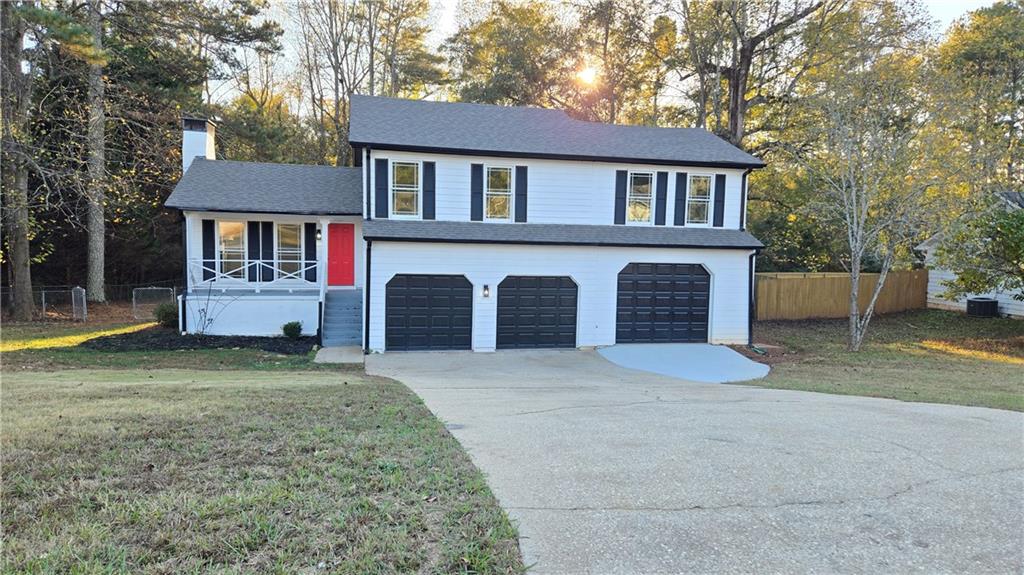 491 Glen Terrace Road Auburn, GA 30011 - Photo 1 of 19 a front view of a house with a yard and garage