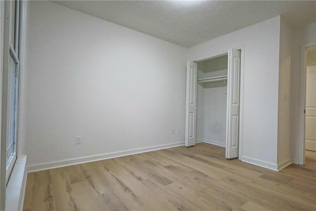 491 Glen Terrace Road Auburn, GA 30011 - Photo 11 of 19 a view of an empty room with wooden floor and closet