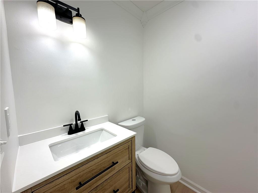 491 Glen Terrace Road Auburn, GA 30011 - Photo 12 of 19 a bathroom with a sink a toilet and mirror
