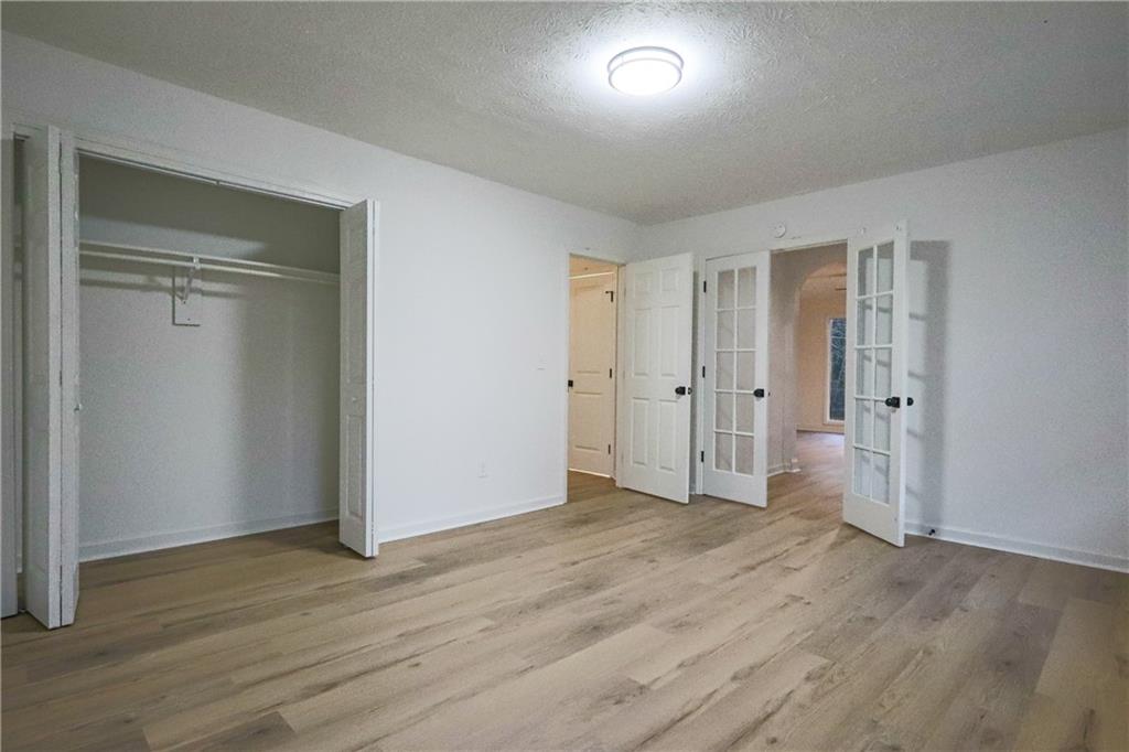 491 Glen Terrace Road Auburn, GA 30011 - Photo 14 of 19 an empty room with wooden floor & closet area