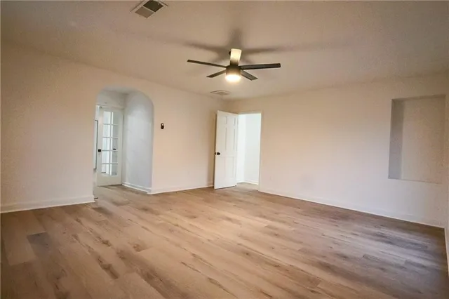 a view of an empty room with a ceiling fan