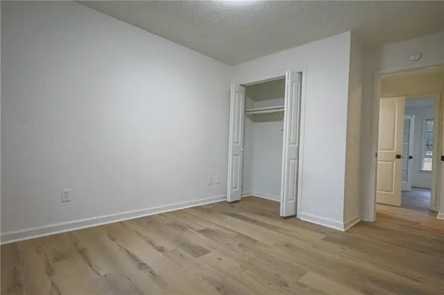 a view of an empty room and wooden floor
