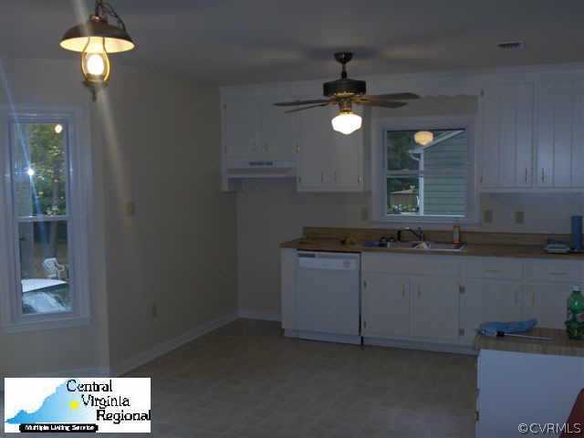15609 Roland View Drive Chester, VA 23831 - Photo 3 of 7 a kitchen with granite countertop a sink cabinets and window