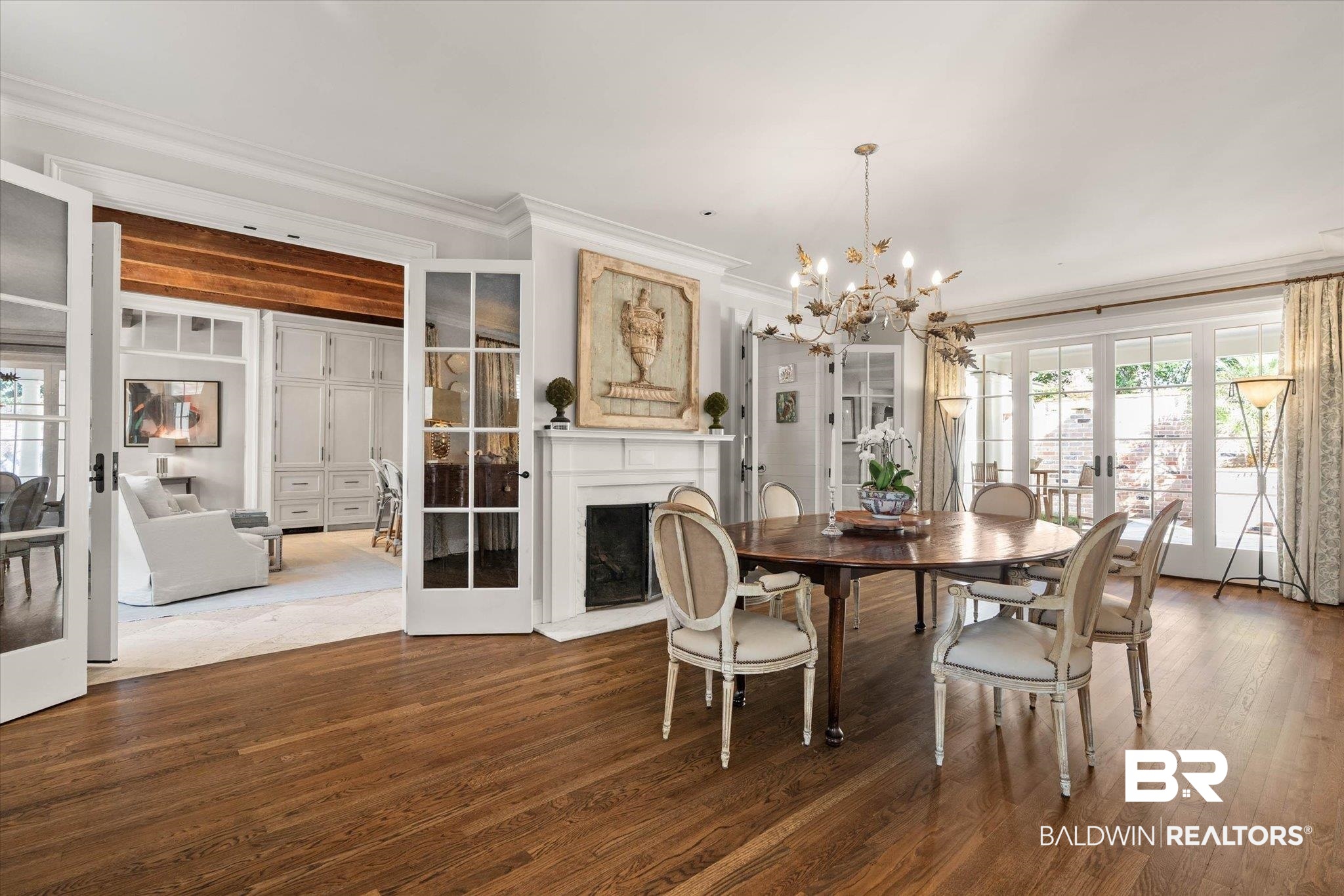 2256 De Leon Avenue Mobile, AL 36607 - Photo 11 of 61 Dining space with french doors, ornamental molding, a fireplace, dark wood-style flooring, and suspended lighting