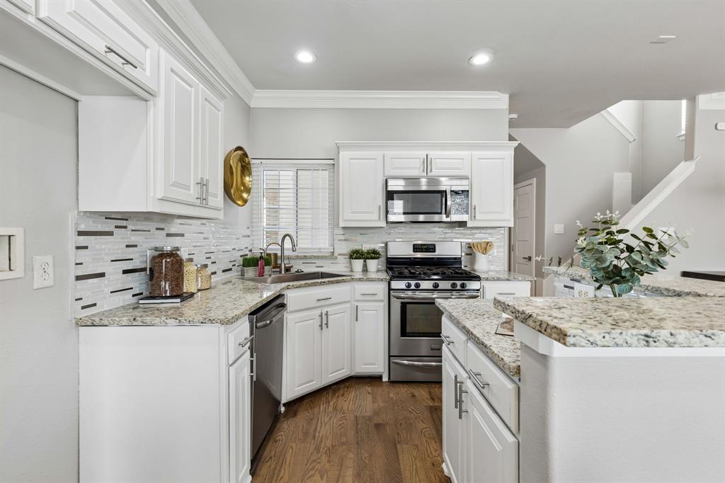 706 South Jupiter Road, Unit 307 Allen, TX 75002 - Photo 9 of 32 White cabinetry with brushed nickel hardware, mosaic tile backsplash