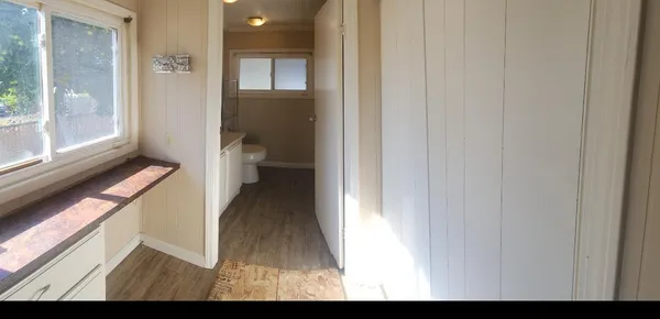 a view of a hallway with toilet and a window
