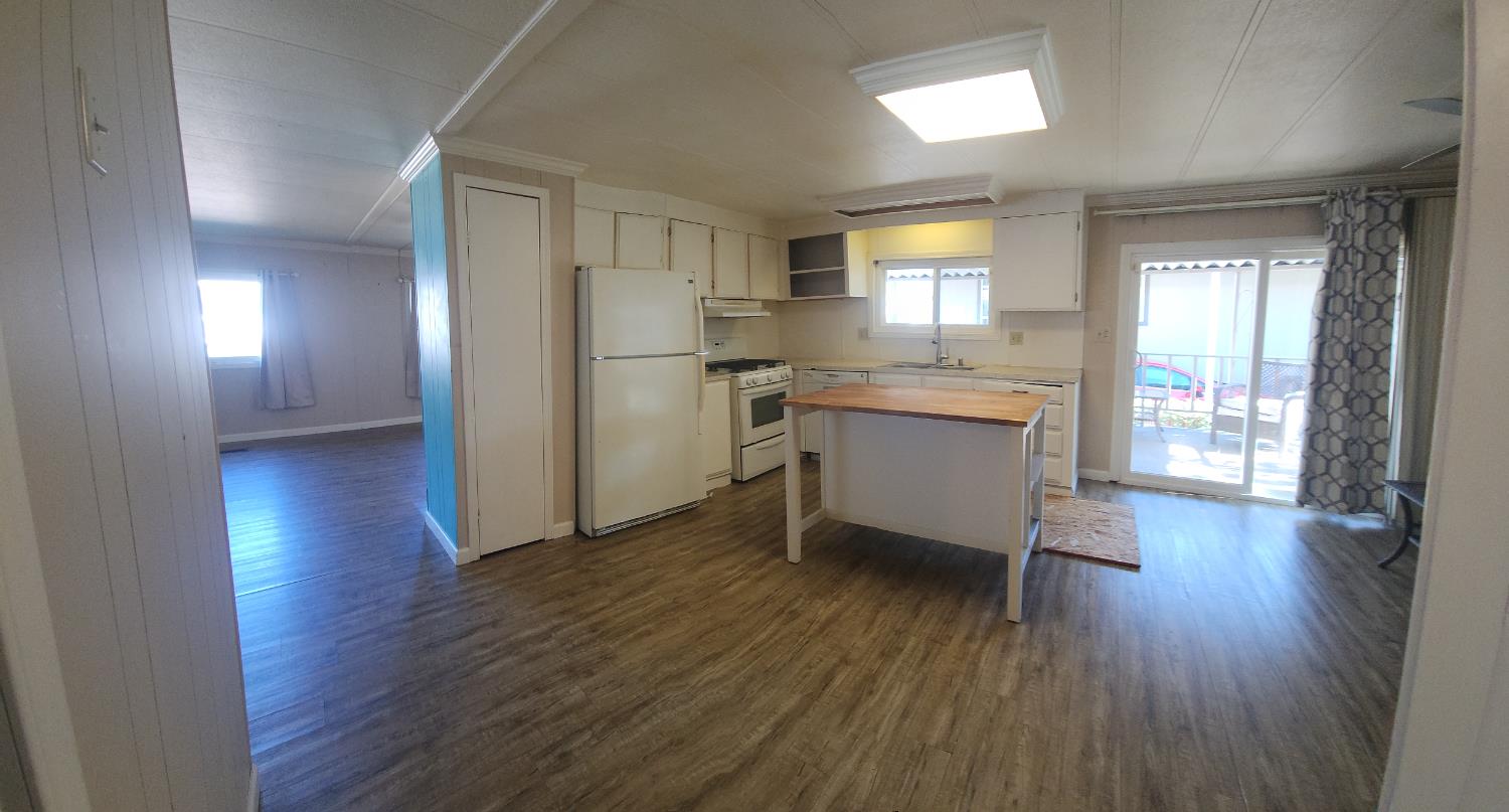 6057 Declaration Circle Citrus Heights, CA 95621 - Photo 18 of 31 a room with kitchen island wooden floor and stainless steel appliances