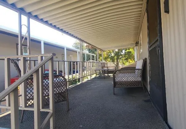 a view of a porch with wooden floor and stairs