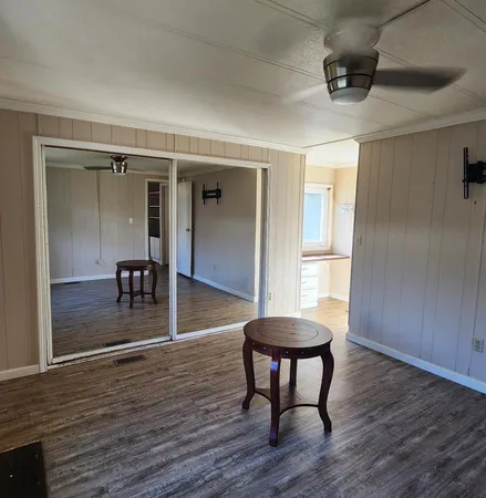 a view of a room with furniture and wooden floor