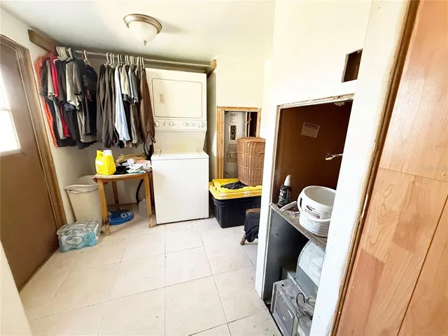 a view of a yard with plants and large trees