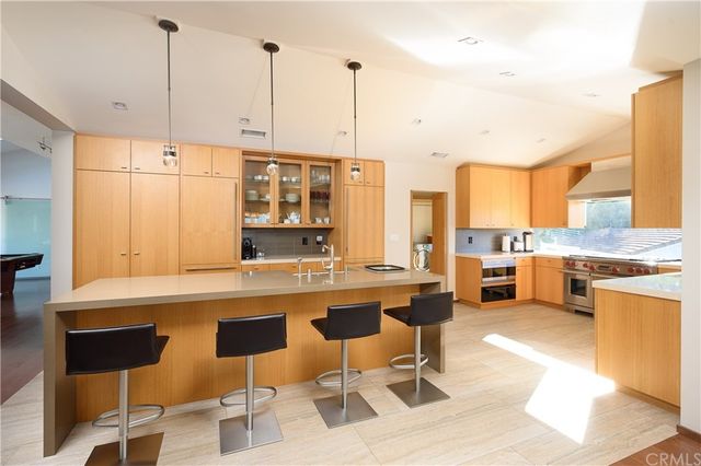a living room with furniture pool table and a flat screen tv