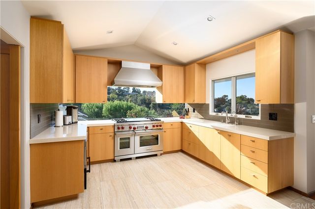 a large room with a large window and furniture