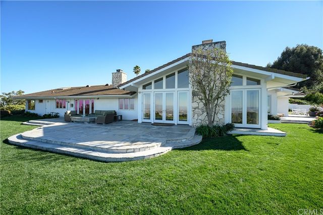 an aerial view of a house with garden space and lake view