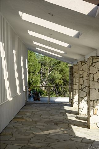 a living room with furniture a fireplace and a large window