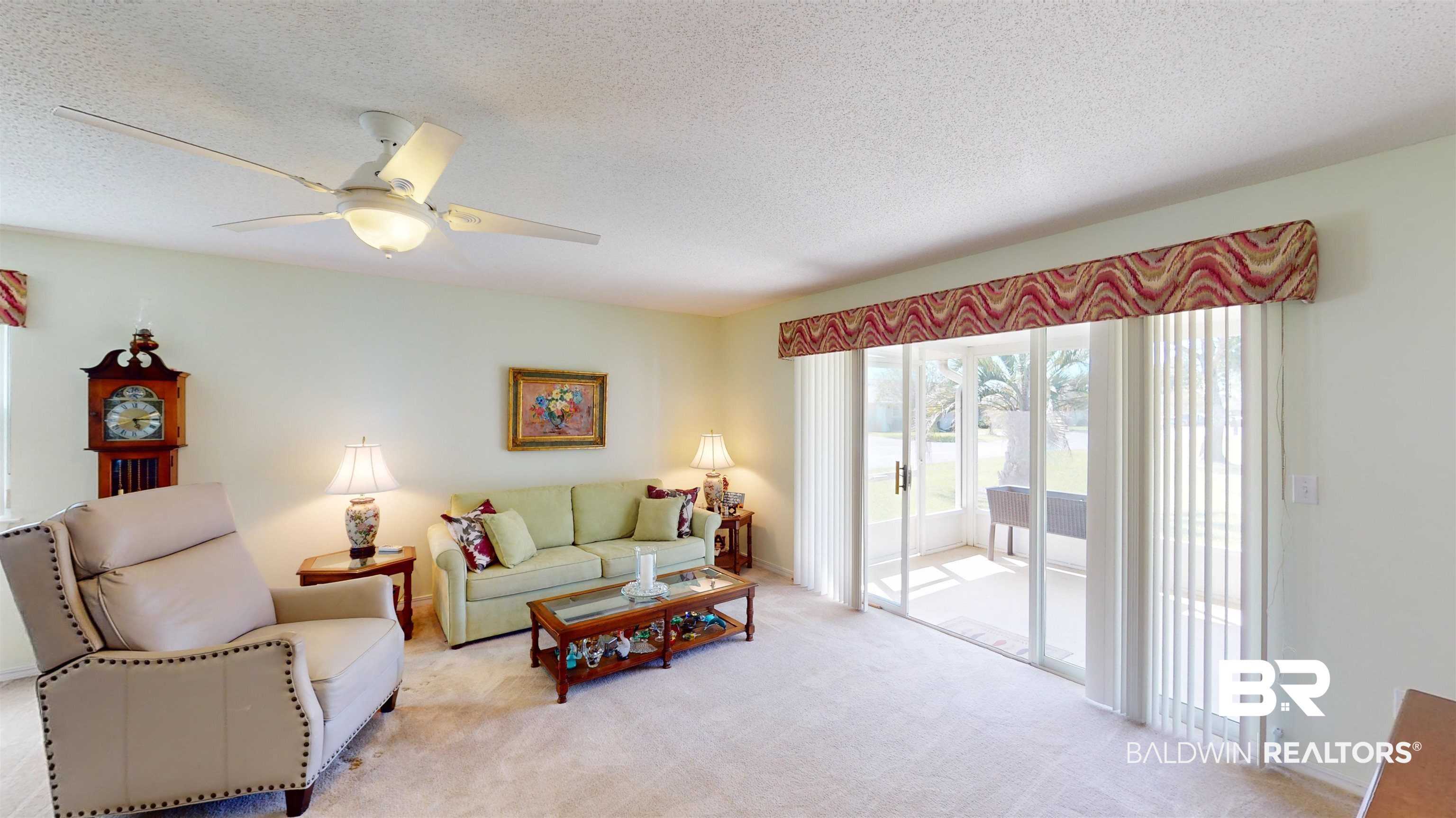 9445 Villas Drive Foley, AL 36535 - Photo 4 of 20 Carpeted living room featuring ceiling fan and a textured ceiling