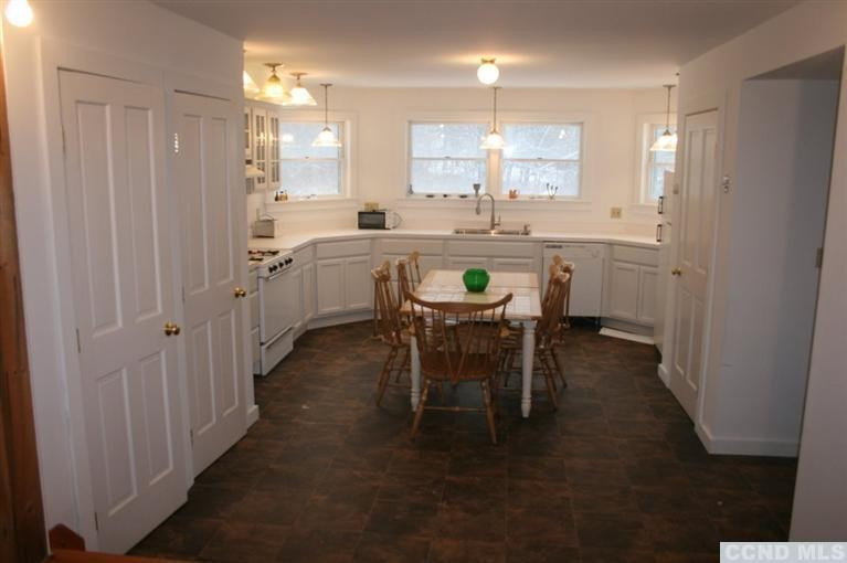 78 Lustig Road Hunter, NY 12485 - Photo 2 of 10 a kitchen with kitchen island granite countertop wooden cabinets a counter top space and stainless steel appliances