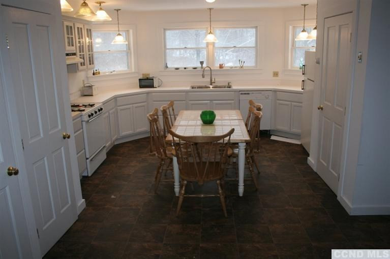 78 Lustig Road Hunter, NY 12485 - Photo 4 of 10 a kitchen with kitchen island a sink stove and white cabinets
