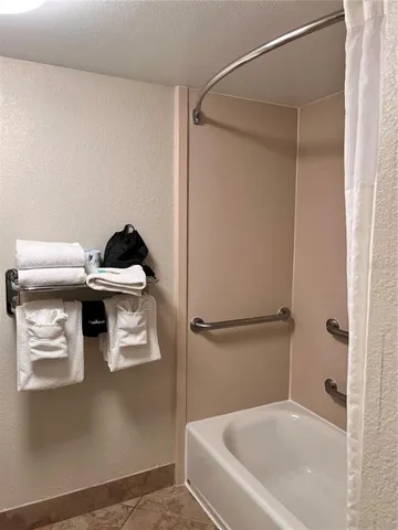 a view of a dining room with furniture a chandelier and wooden floor