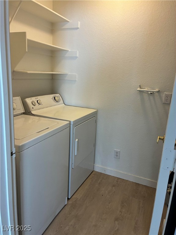701 Capri Drive, Unit 5C Boulder City, NV 89005 - Photo 5 of 8 Washroom featuring light wood-type flooring, washer and clothes dryer, and a textured wall
