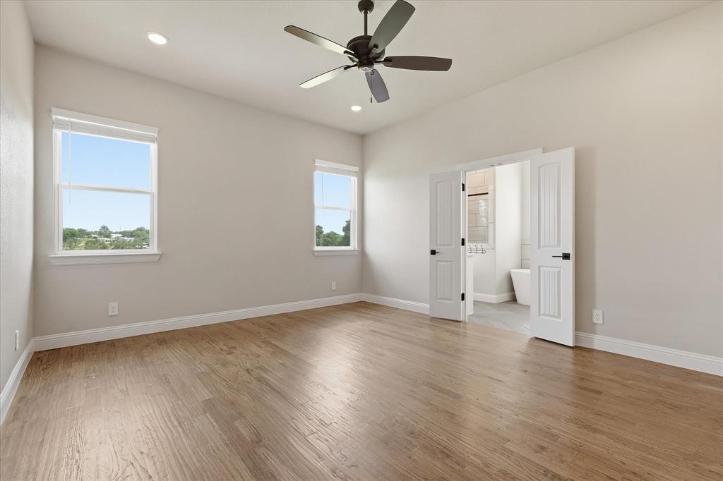 120 Grace Vw Road Weatherford, TX 76088 - Photo 16 of 40 Spacious master bedroom featuring vaulted ceilings, recessed lighting, and wood-finish flooring