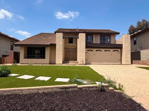 a front view of a house with a yard