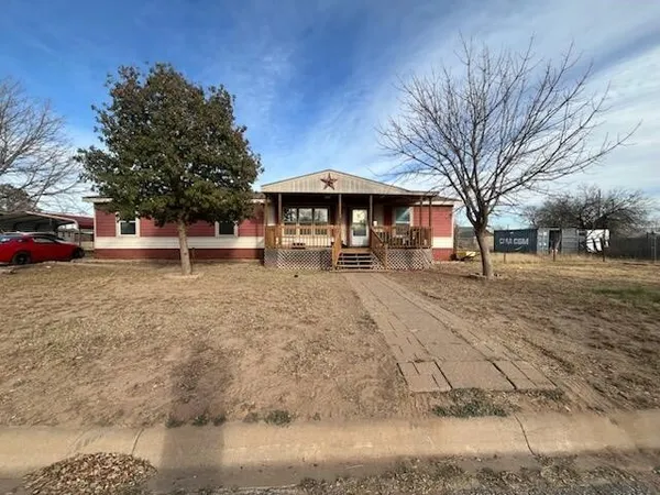 a view of a yard with a bench and trees