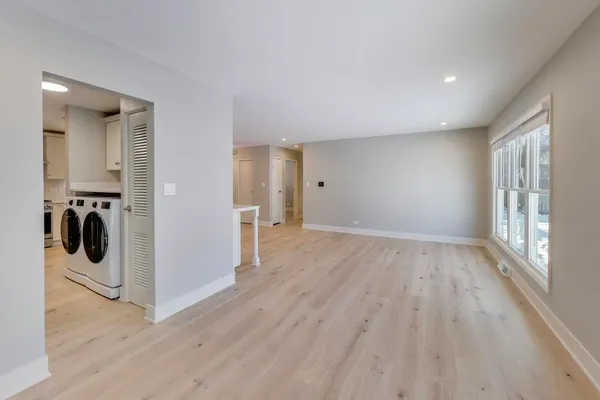 a kitchen with white cabinets and white appliances