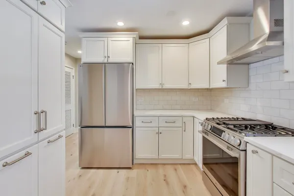 a view of a kitchen with a sink dishwasher and fireplace