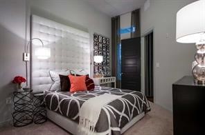 2525 McCue Road, Unit 535 Houston, TX 77056 - Photo 10 of 16 a bedroom with a bed and a potted plant