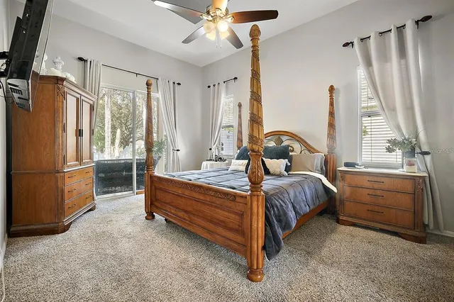 a bedroom with a bed next to a window