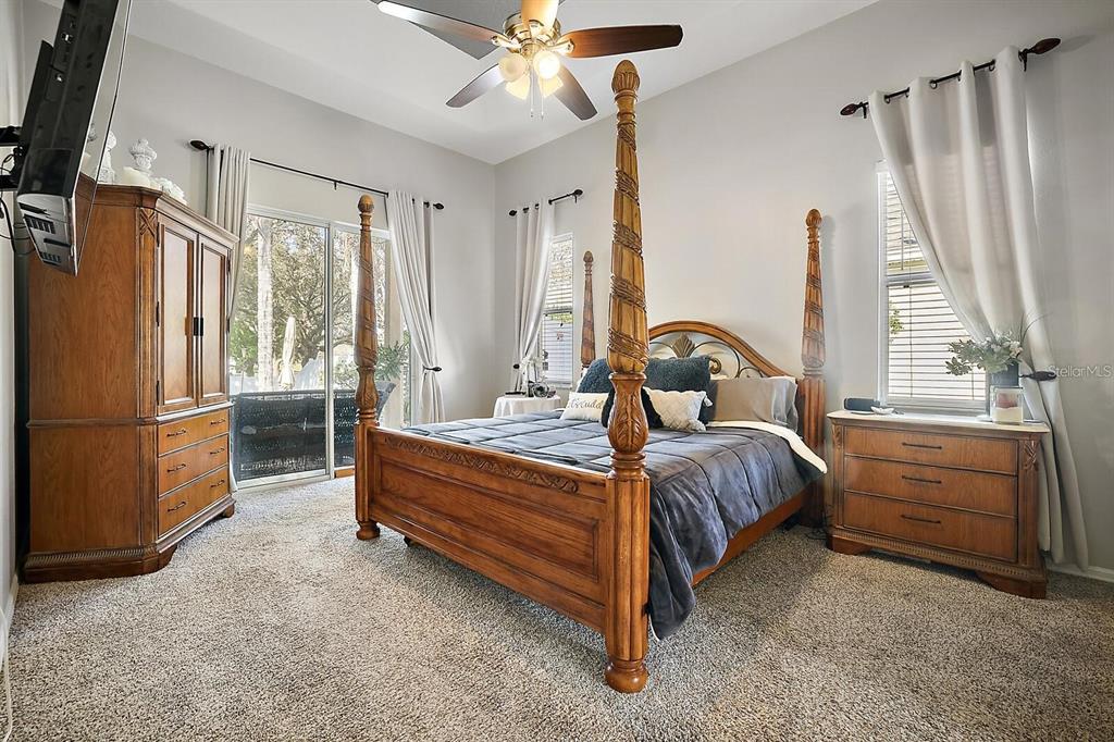 2847 Majestic Isle Drive Clermont, FL 34711 - Photo 12 of 25 a bedroom with a bed next to a window