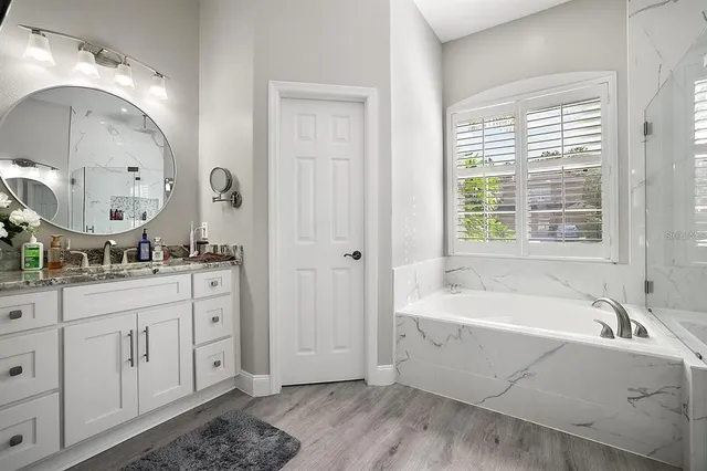 a spacious bathroom with sink shower and bathtub