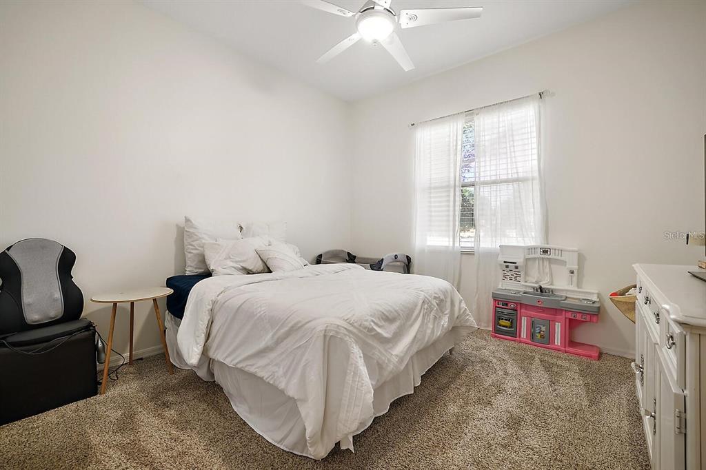 2847 Majestic Isle Drive Clermont, FL 34711 - Photo 17 of 25 a bedroom with a bed and a window